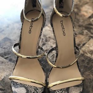Bebe Snakeskin heels with gold straps